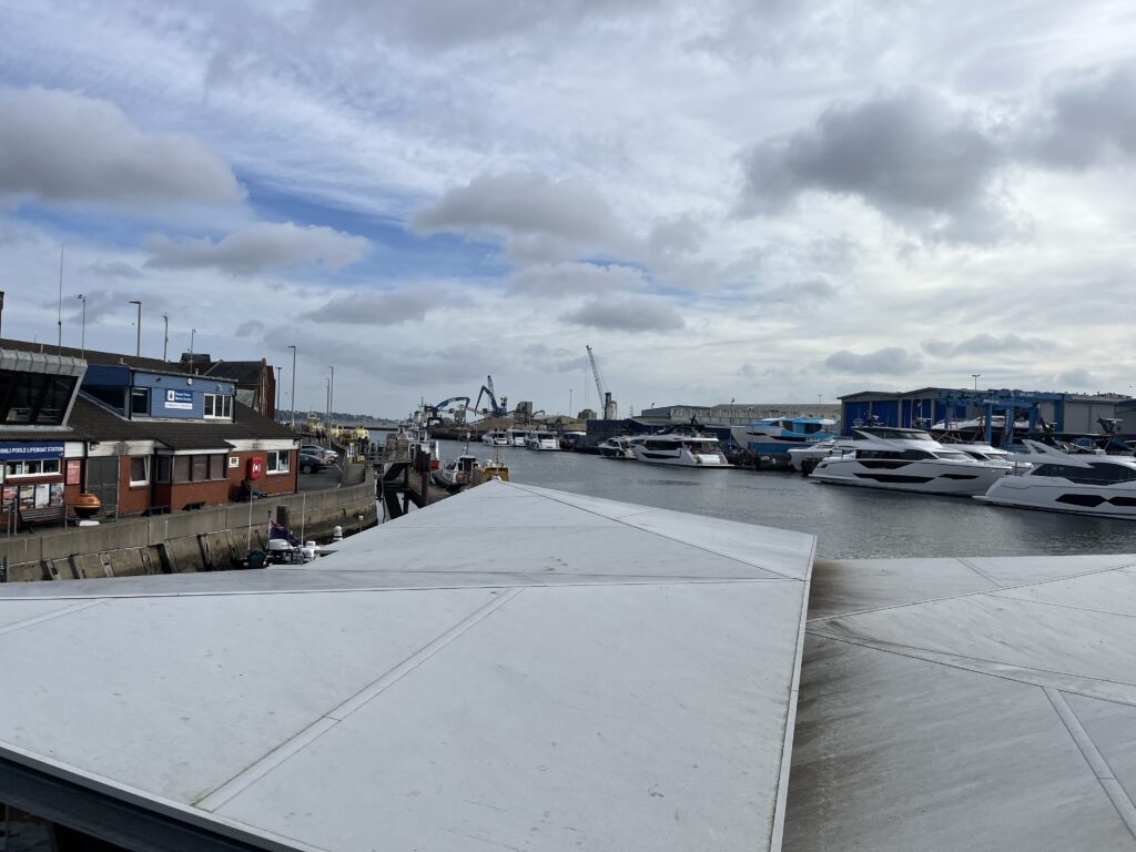 Photo of boats, ships and vessels moored up in Poole Harbour. Photo of a harbour and maritime industry with marine and coastal waters